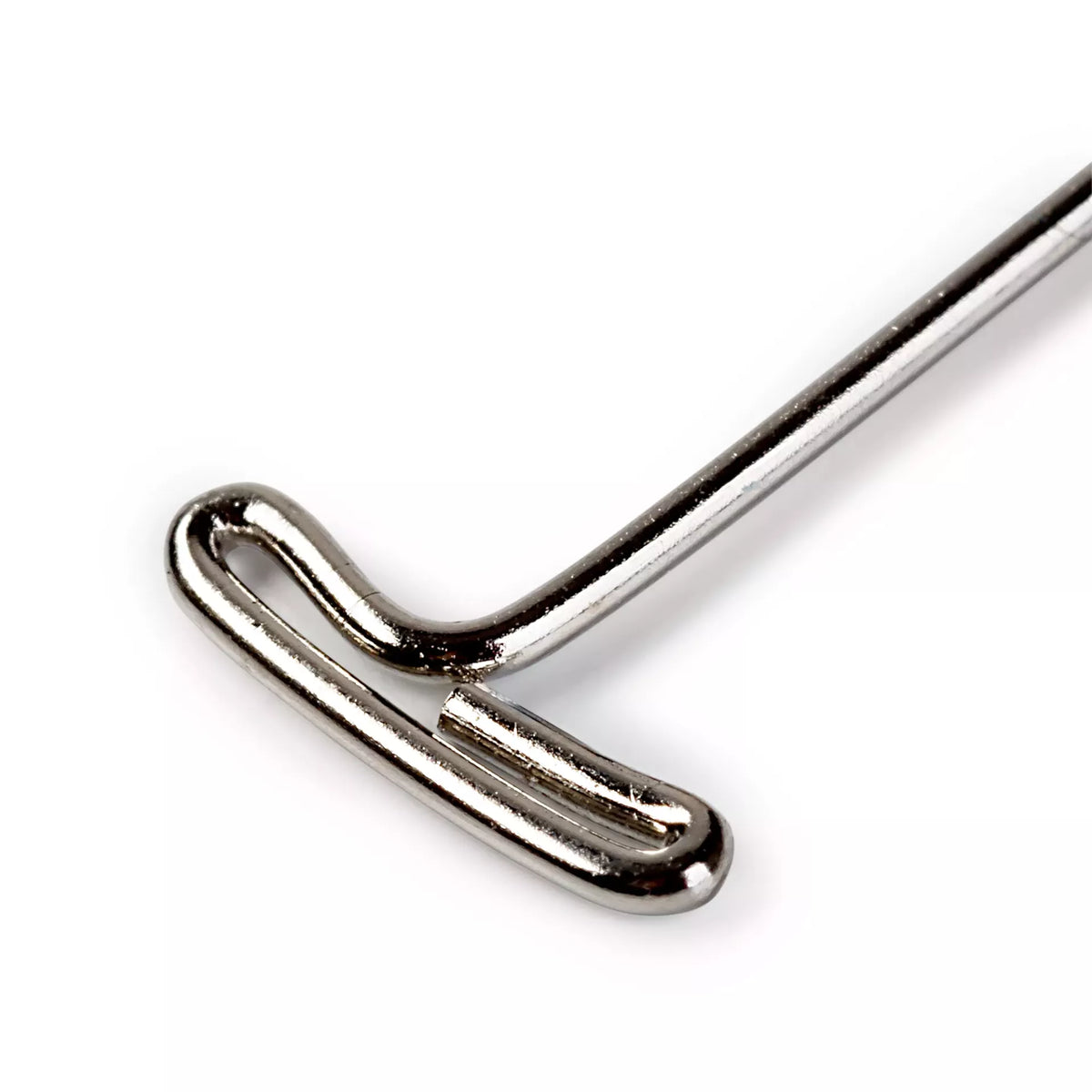Close-up of a silver-colored steel T-shaped head pin for packaging and handicraft.