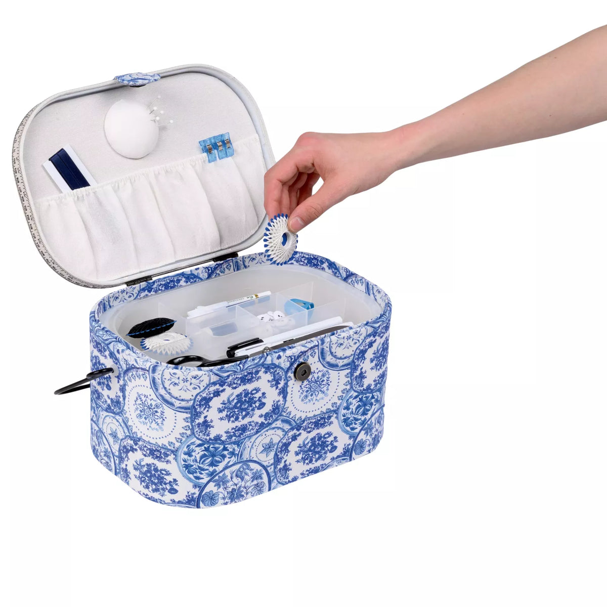 Large oval sewing basket in Delft Blue pattern with open lid, plastic insert, and pincushion.