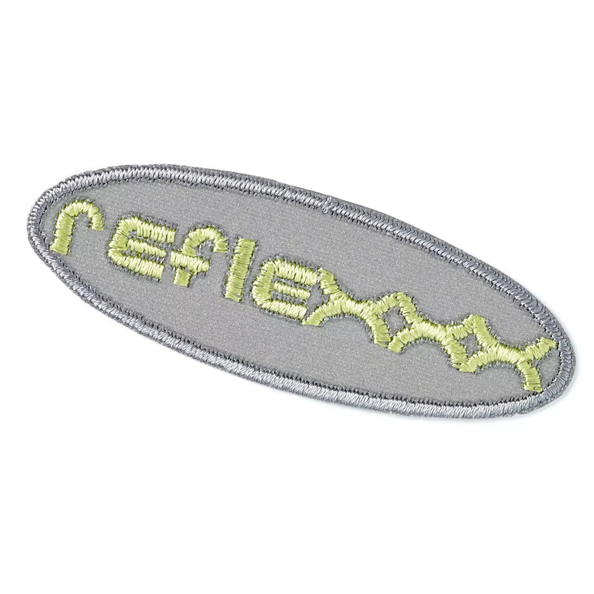 Oval grey reflective applique with the word reflex embroidered in lime green.