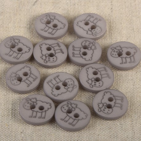 A collection of grey 15mm polyester sewing buttons featuring an engraved sheep design.