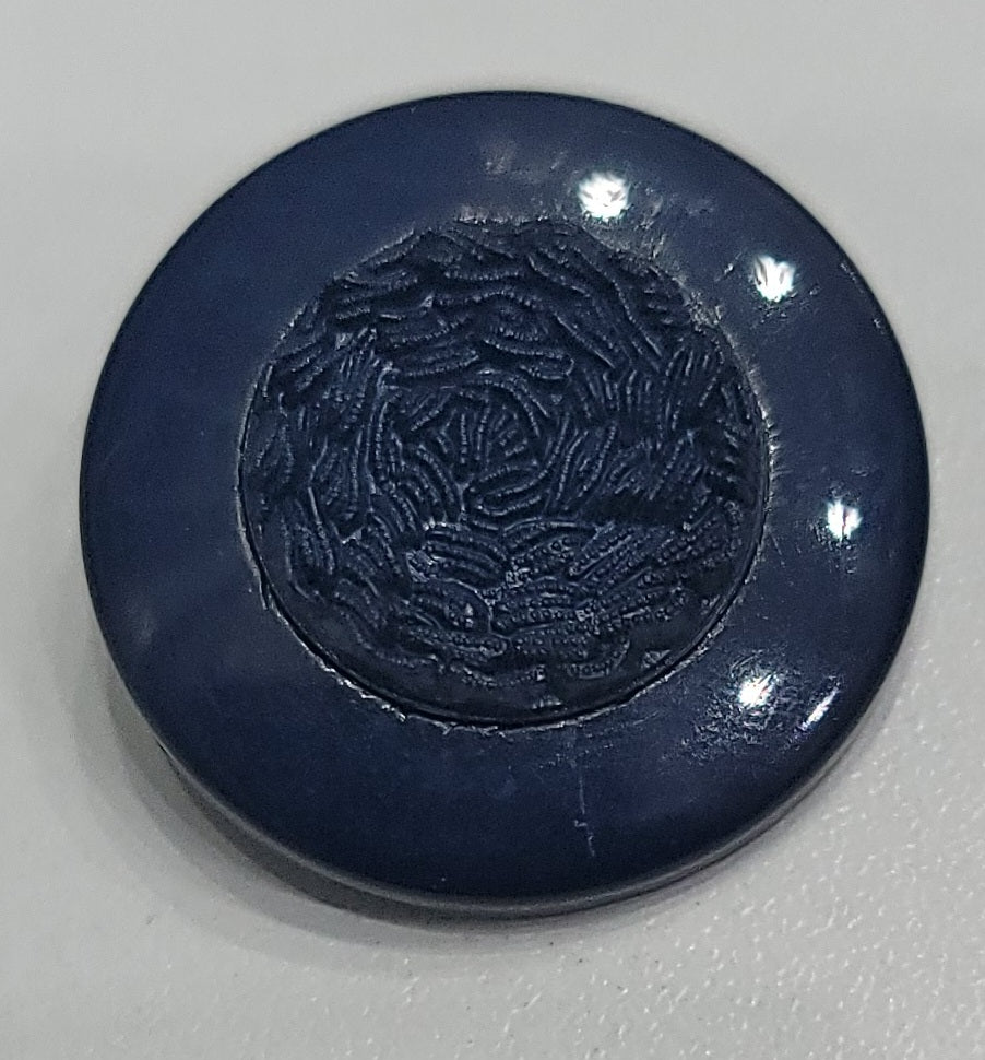 Dark blue polyester button with a circular embossed pattern.