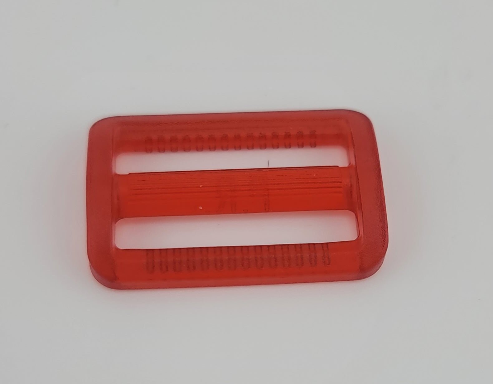 Red plastic 30mm adjuster buckle with textured edges.