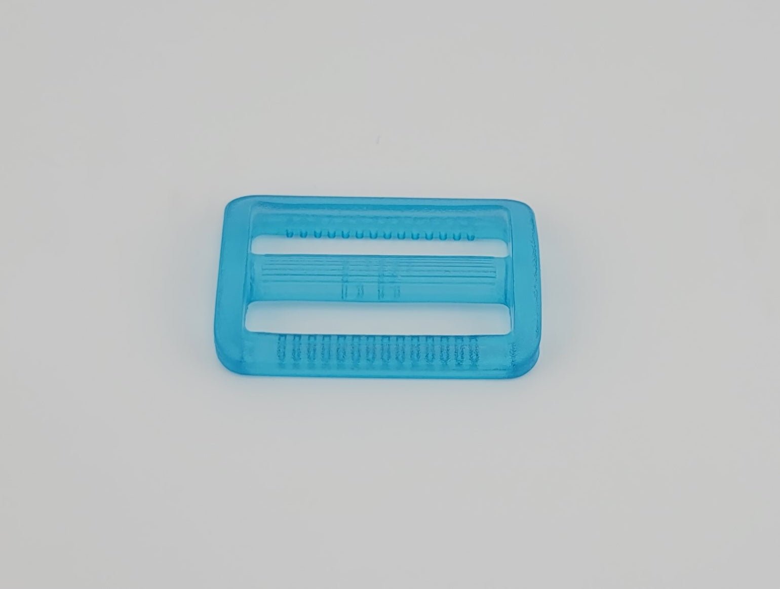 A blue plastic 30mm adjuster buckle with textured surfaces.