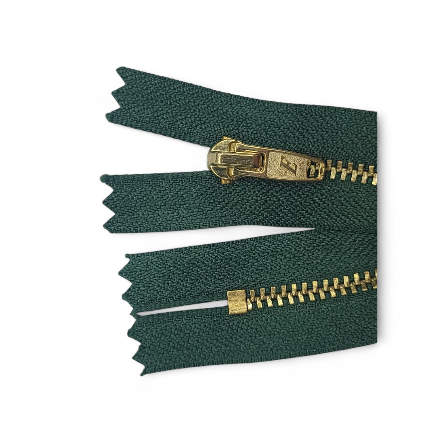 YKK size 3 closed end gold metal zip with dark green tape.