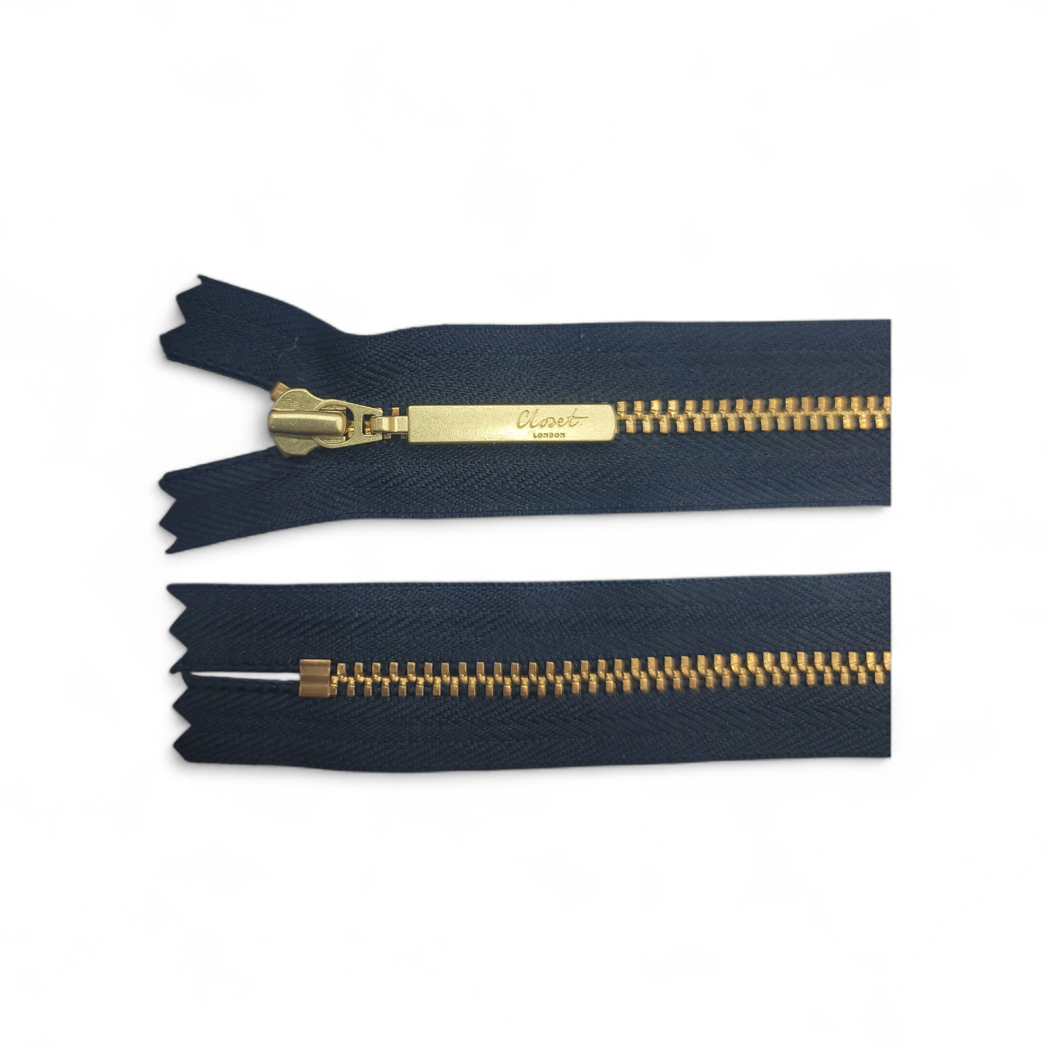 YKK size 3 closed end gold metal zip with a branded pull tab.