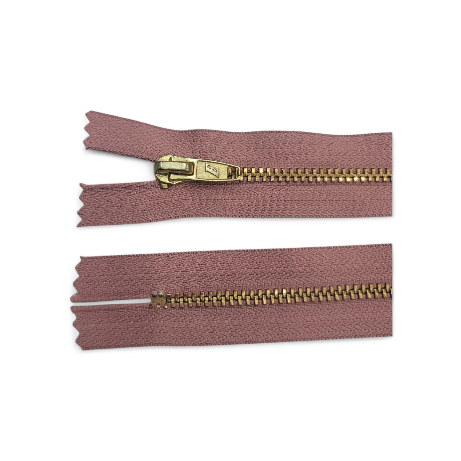 YKK size 3 closed end gold metal zipper with pink fabric.