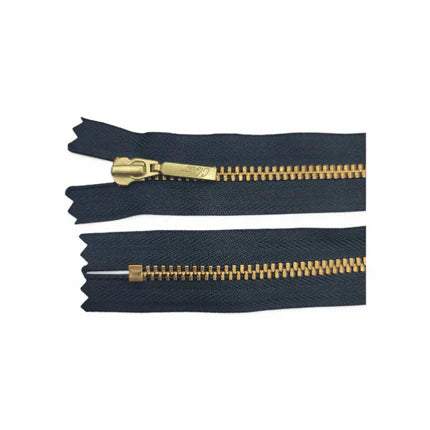 YKK size 3 closed end gold metal zipper with black tape.
