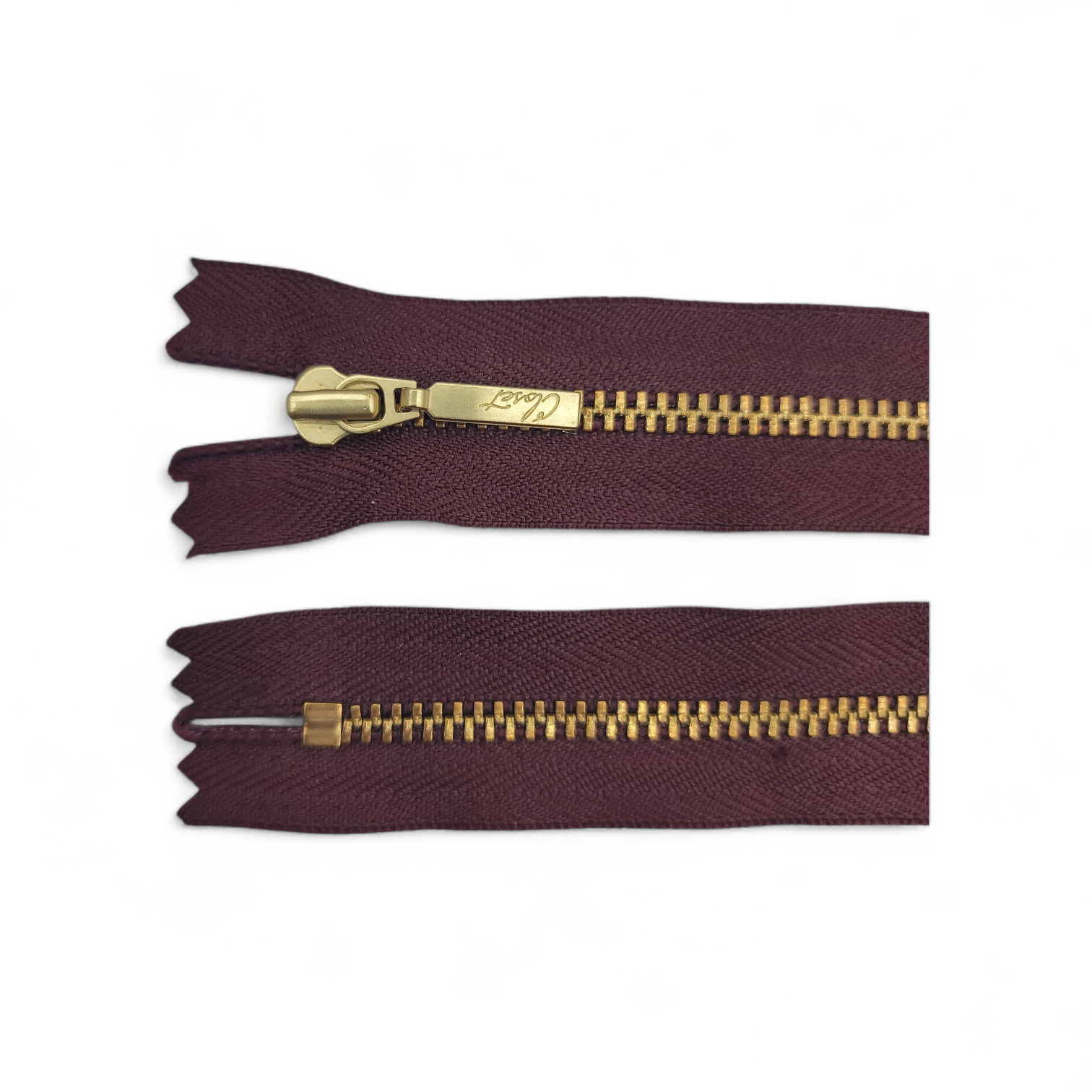 YKK size 3 closed end gold metal zipper with burgundy tape.