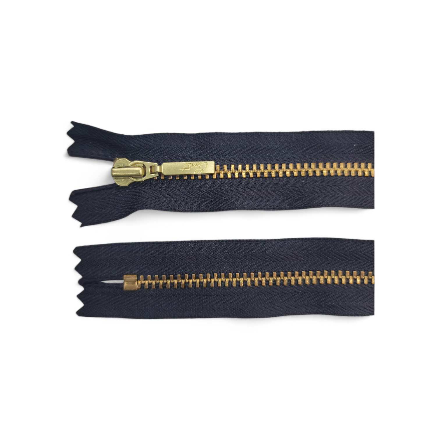 YKK size 3 closed end gold metal zipper with dark fabric.