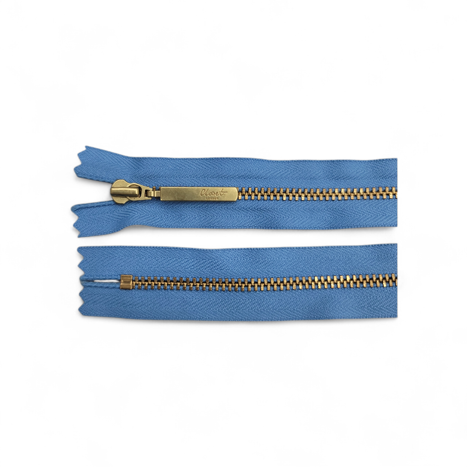 YKK Size 3 closed end gold metal zip with blue fabric.