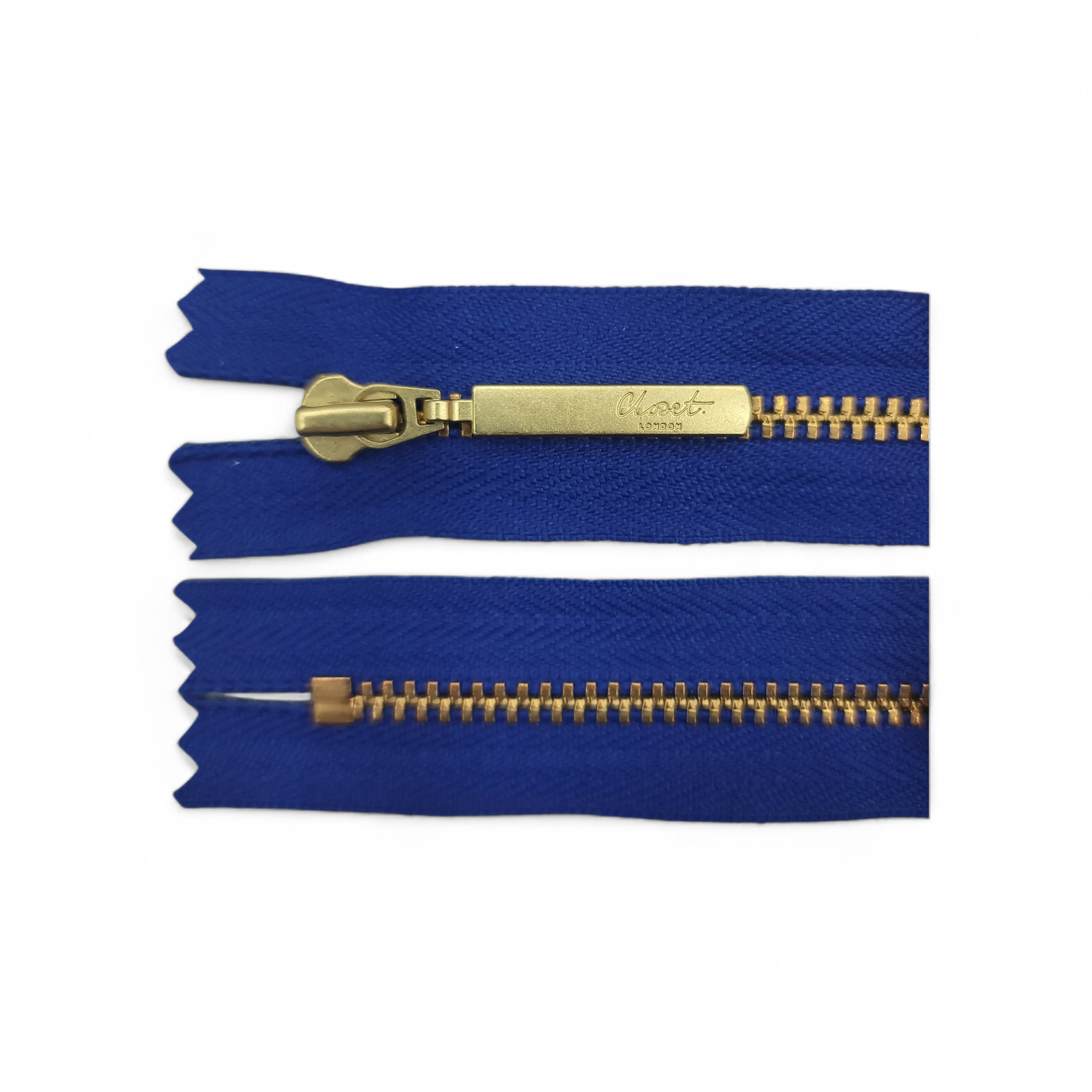 YKK size 3 closed end gold metal zip on blue fabric.