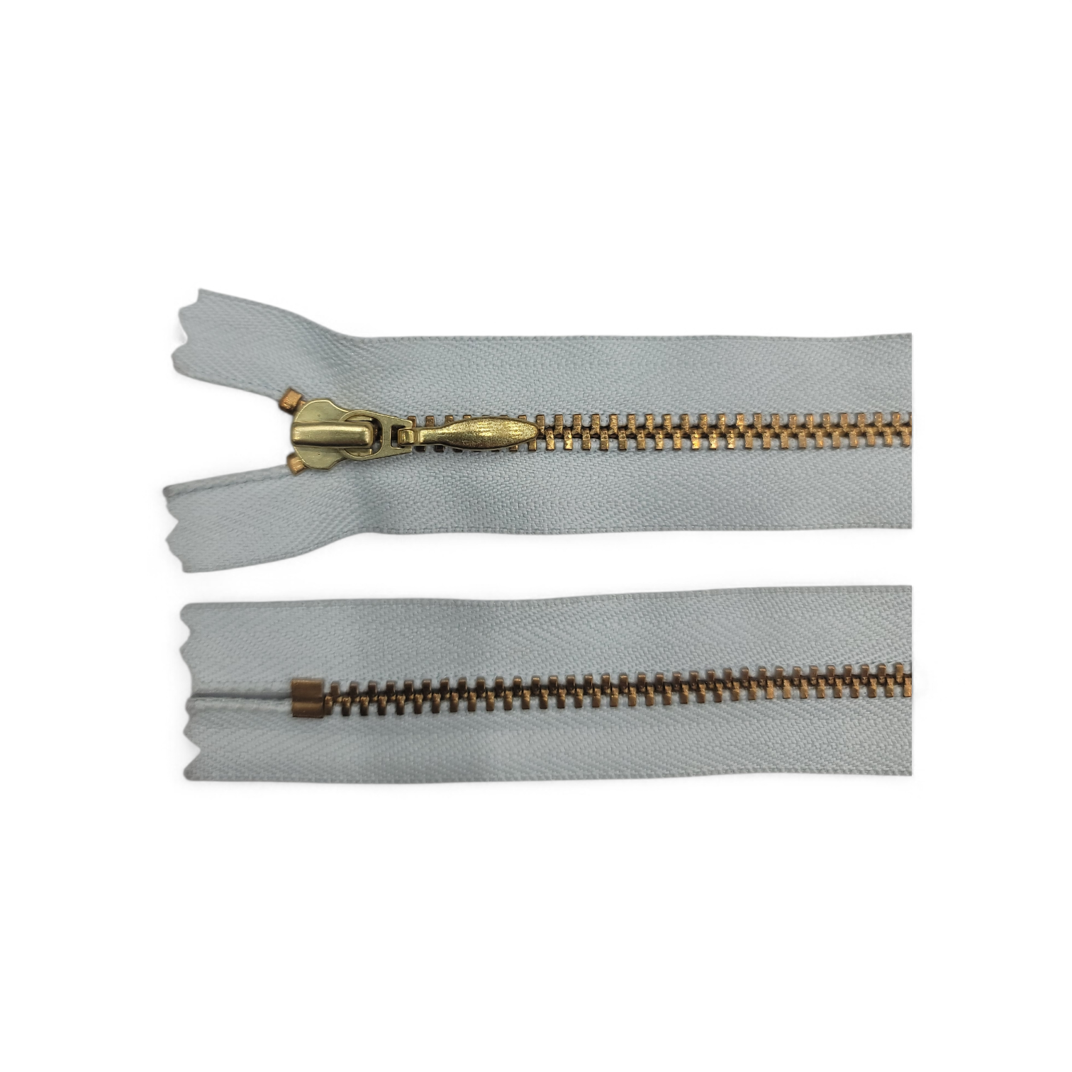 YKK size 3 closed end gold metal zipper with light grey tape.