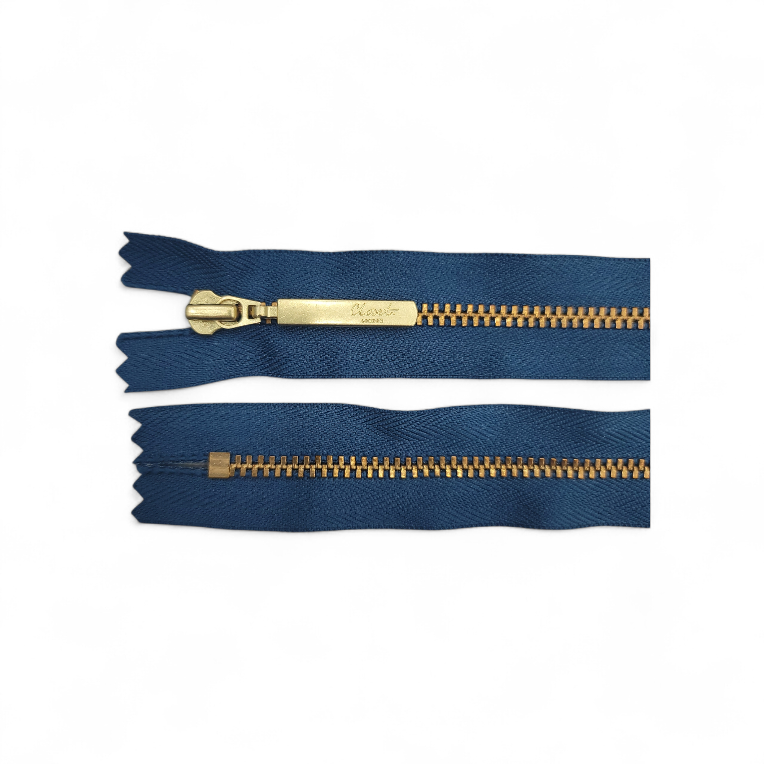 YKK size 3 closed end gold metal zip on navy fabric.