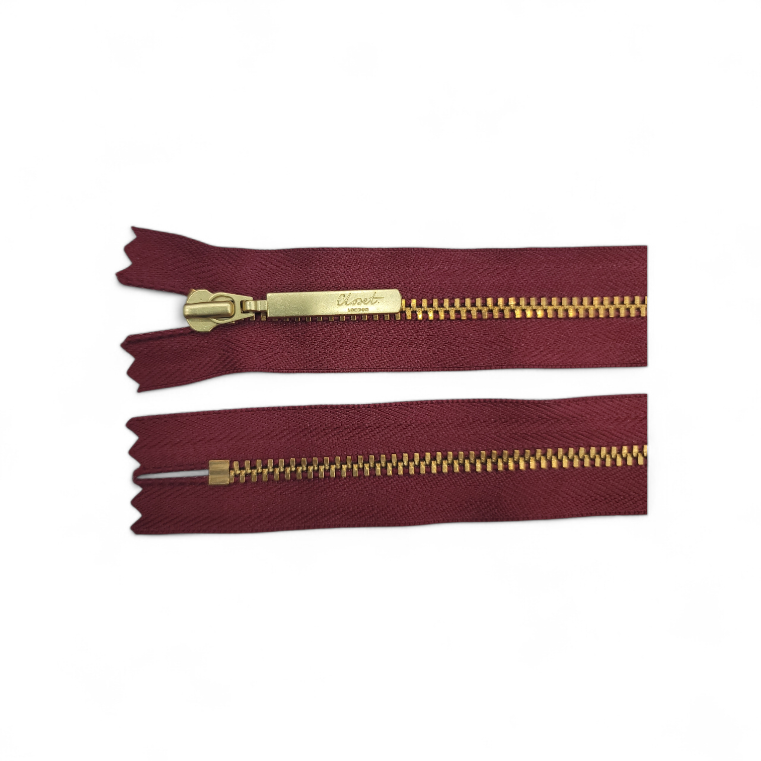 YKK Size 3 closed end gold metal zip with burgundy tape.