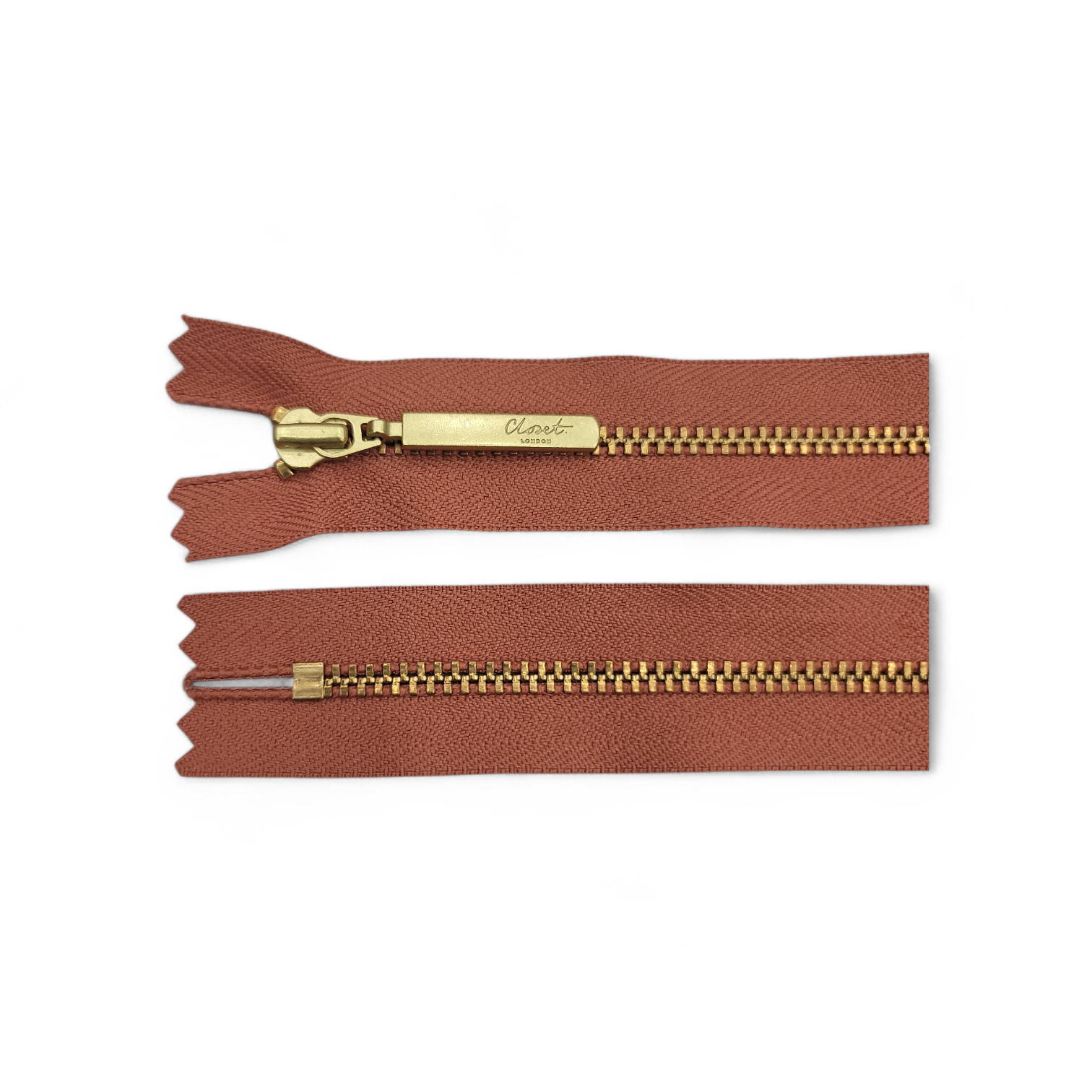 YKK Size 3 closed end gold metal zipper with brown tape.