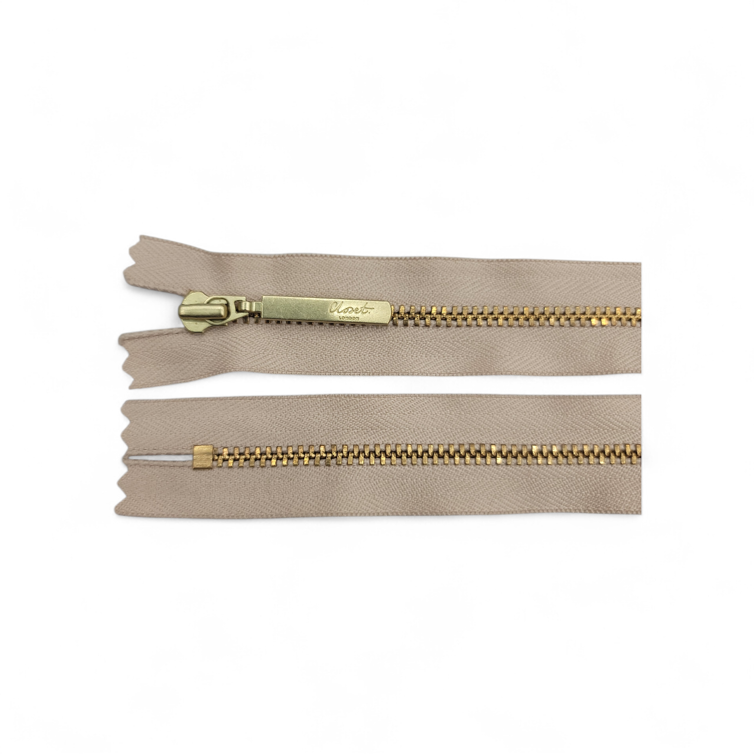 YKK size 3 closed end gold metal zipper with beige tape.