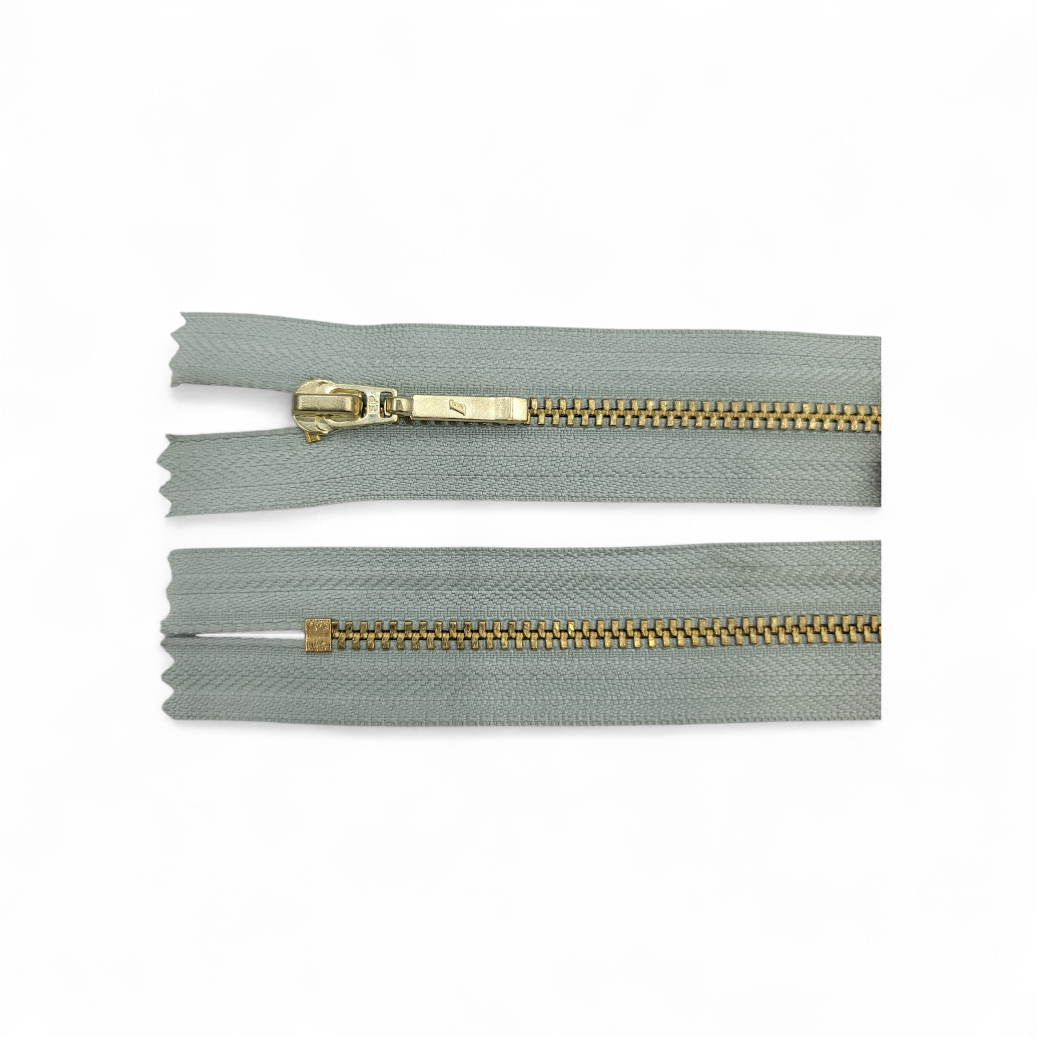 YKK size 3 closed end gold metal zipper with grey tape.