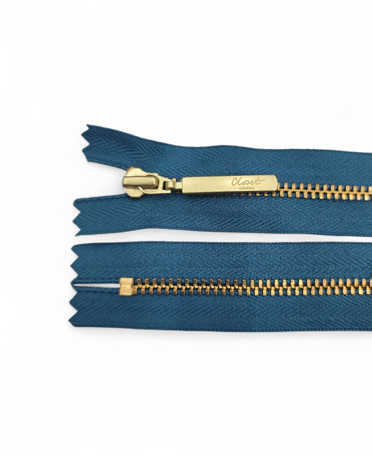 YKK size 3 closed end gold metal zip with teal fabric.