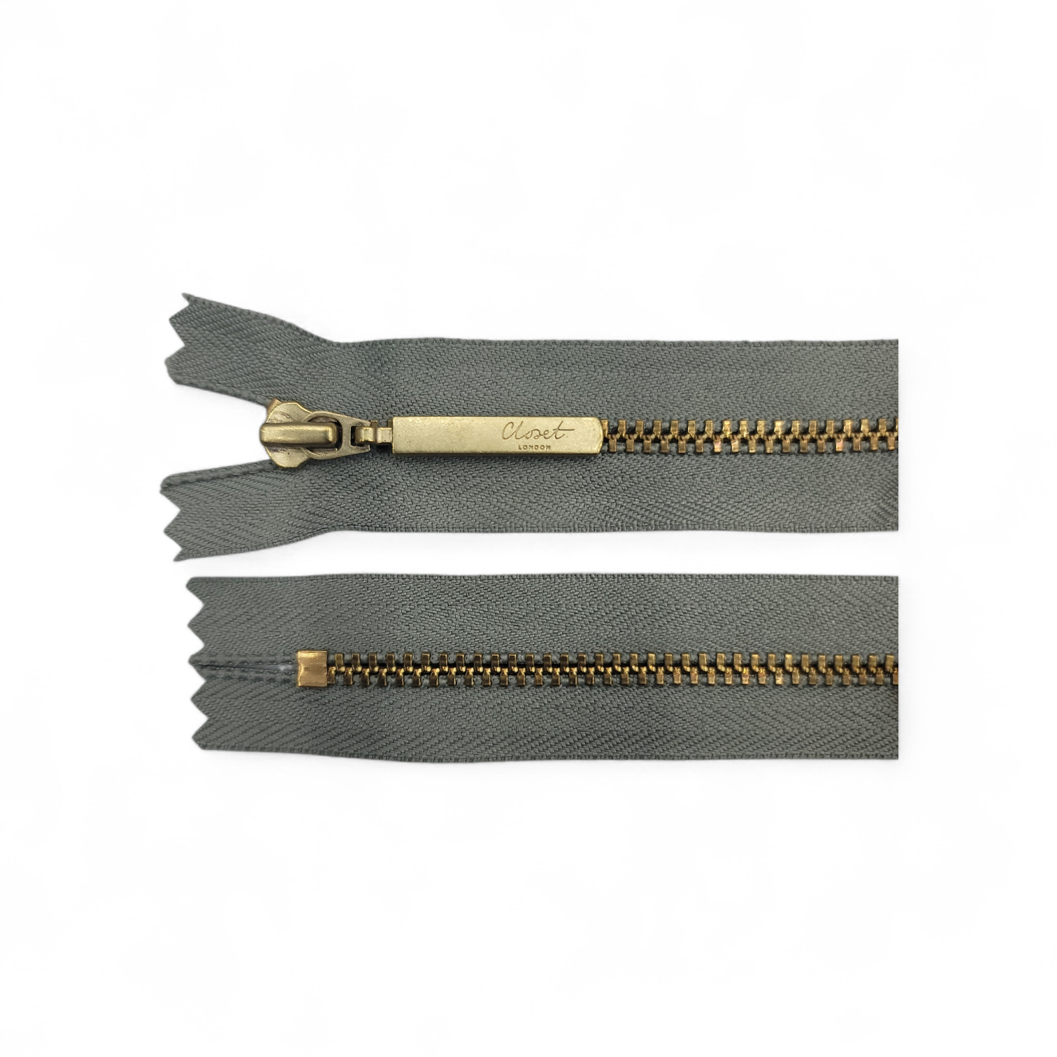 YKK size 3 closed end gold metal zip with grey tape.