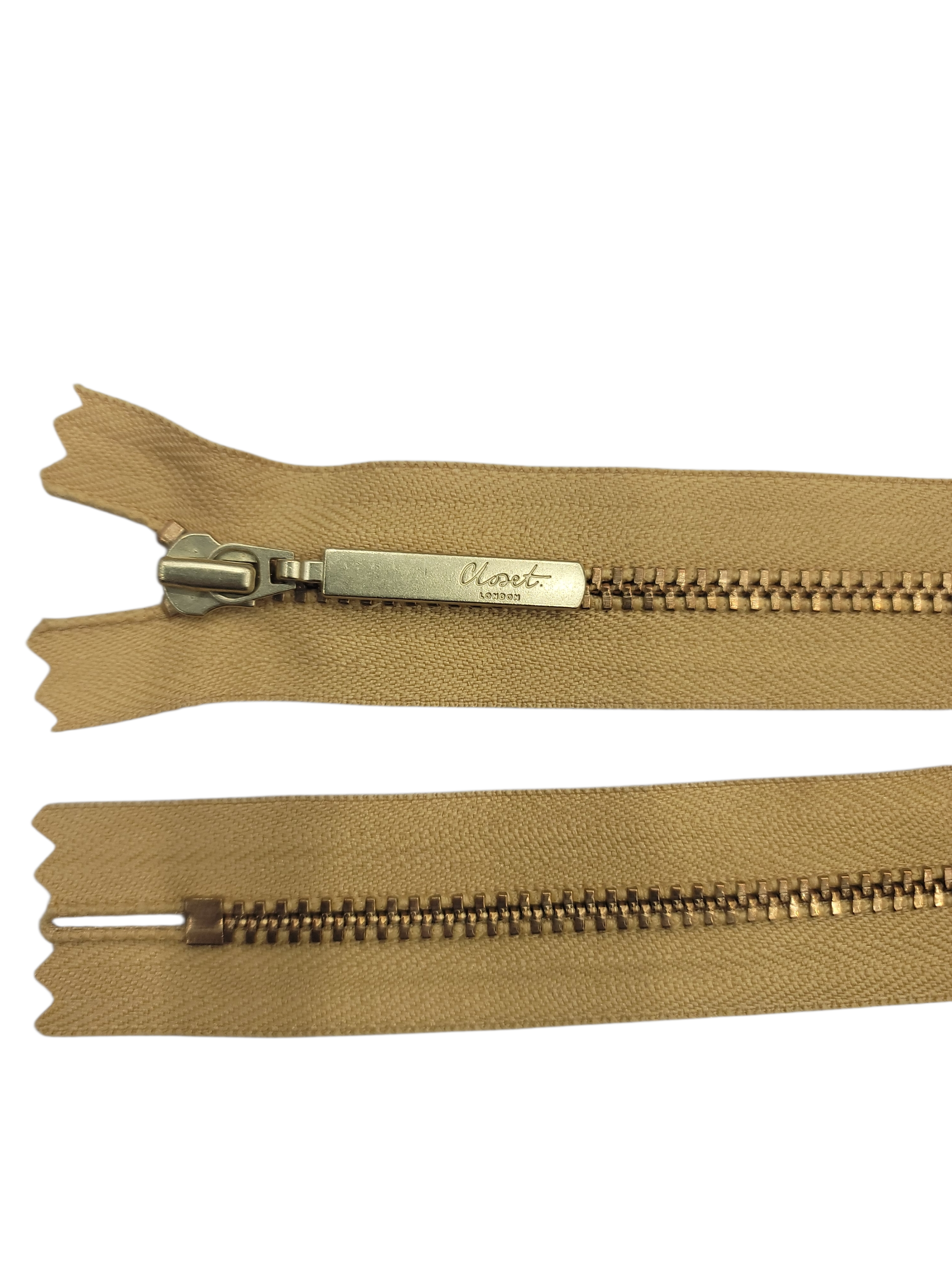 YKK size 3 closed end gold metal zip with beige tape.