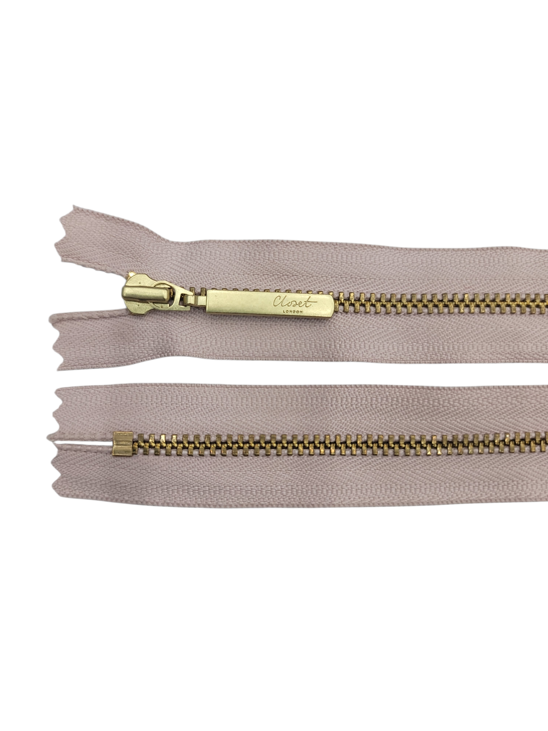 YKK Size 3 closed end gold metal zip with beige tape.