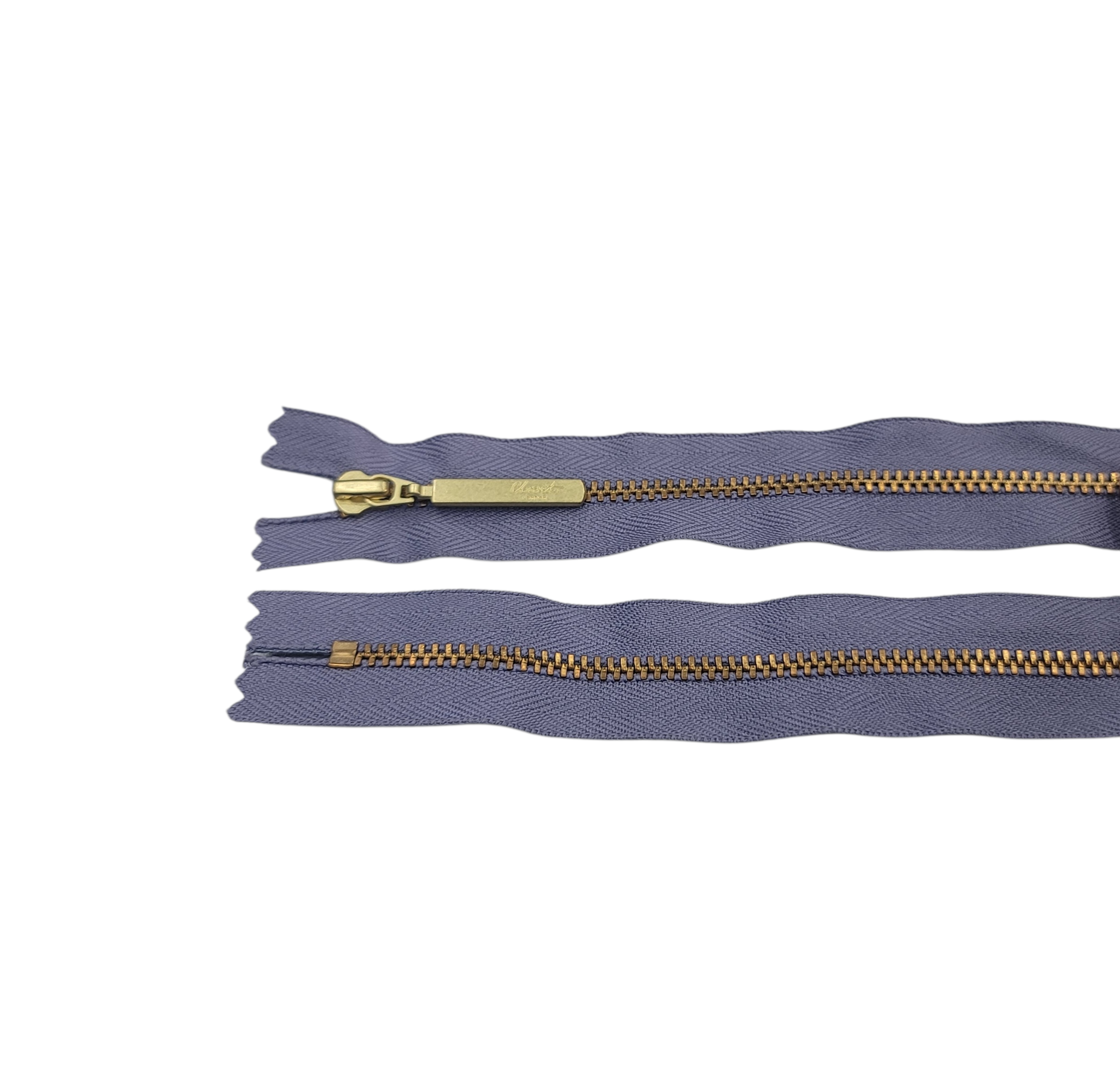 YKK size 3 closed end gold metal zipper with purple fabric.