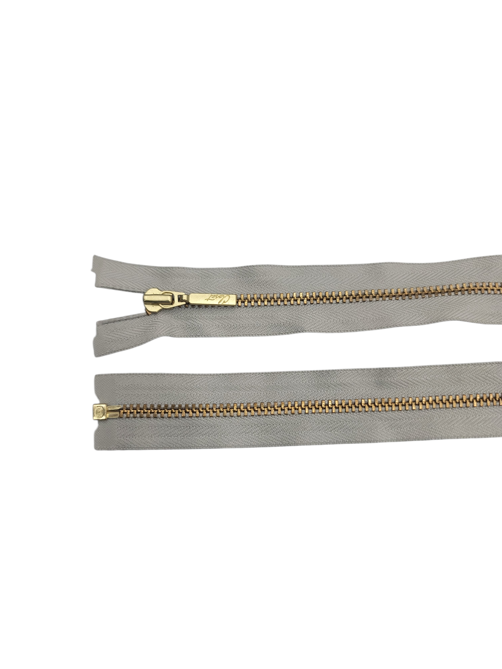 YKK size 3 open end gold metal zipper with grey tape.