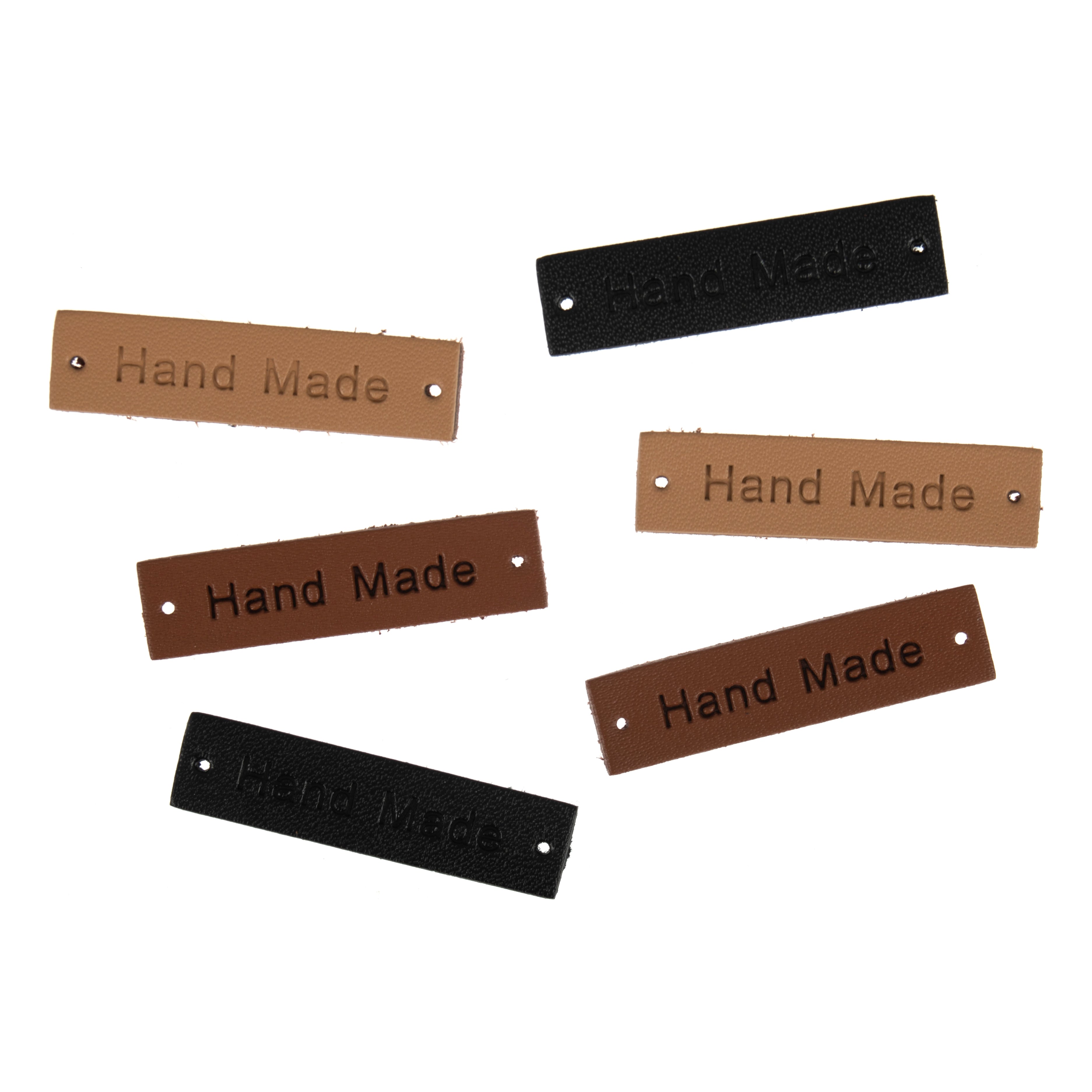 Six rectangular leather labels in black, tan, and brown, each embossed with the words Hand Made.