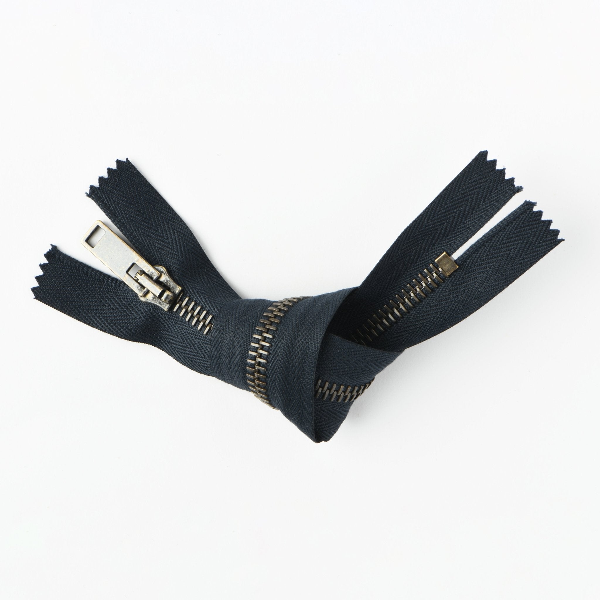 RIRI brass metal zipper, 24cm closed end fastener with a dark fabric tape.
