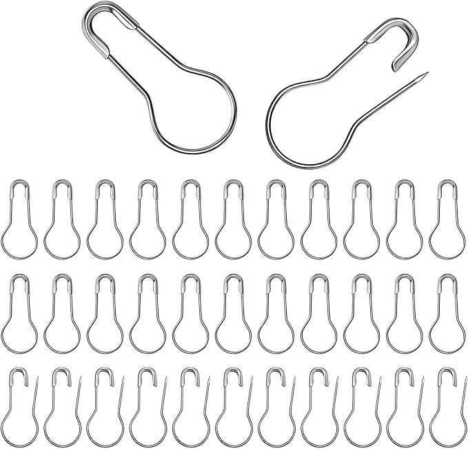 A collection of silver metal bulb safety pins shown in closed and open positions.