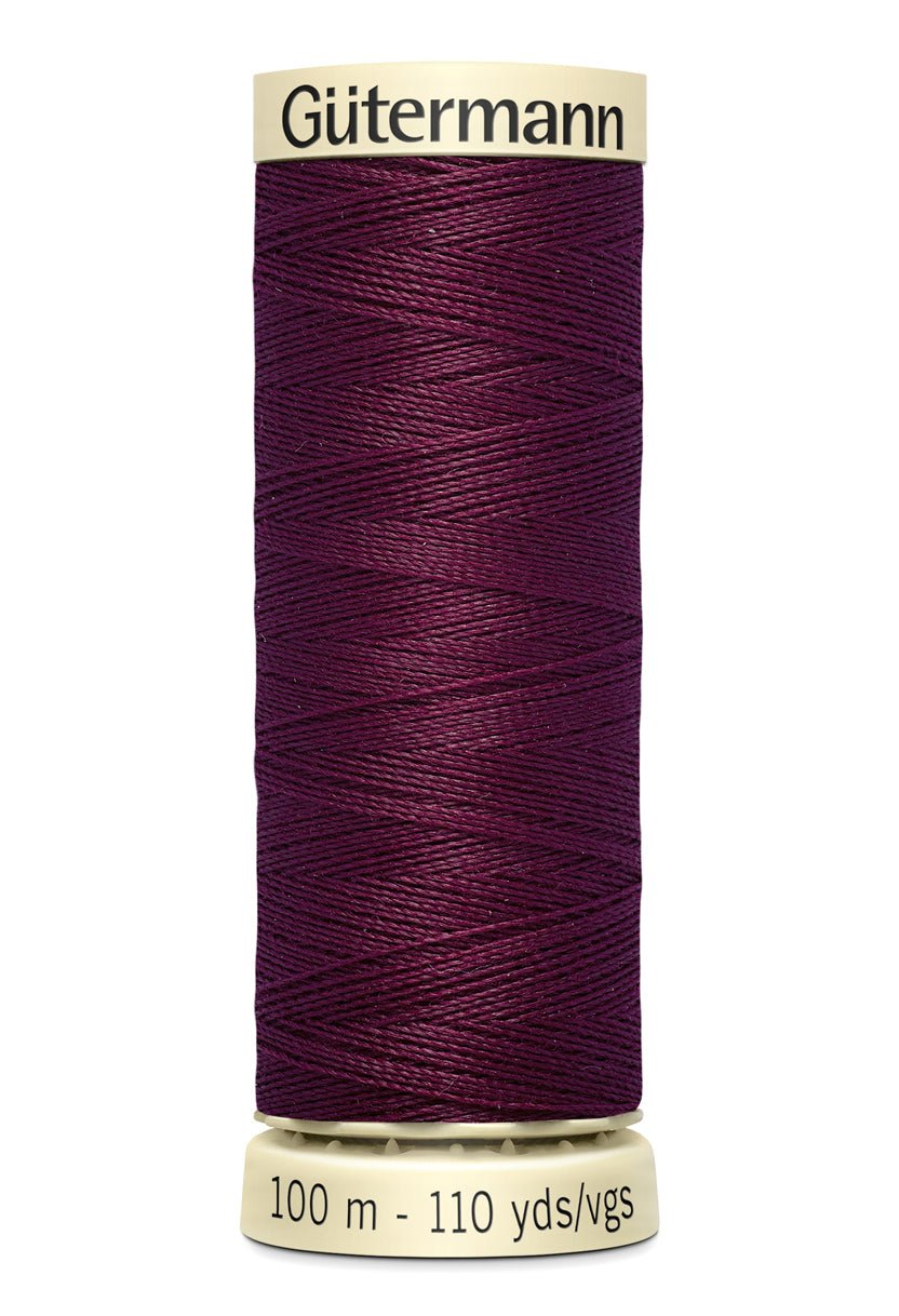 Gütermann Sew-All thread spool in a deep purple color.