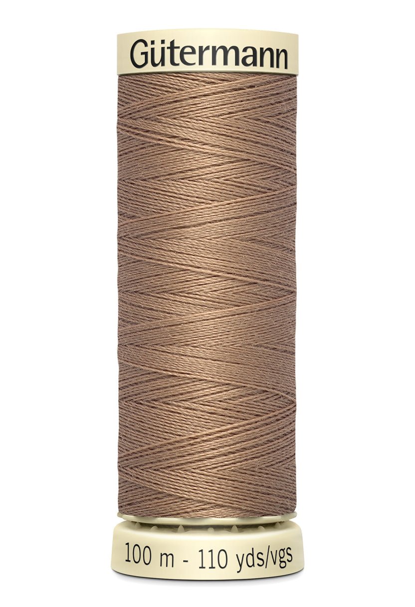 Gutermann Sew-All thread in a neutral brown color on a spool.