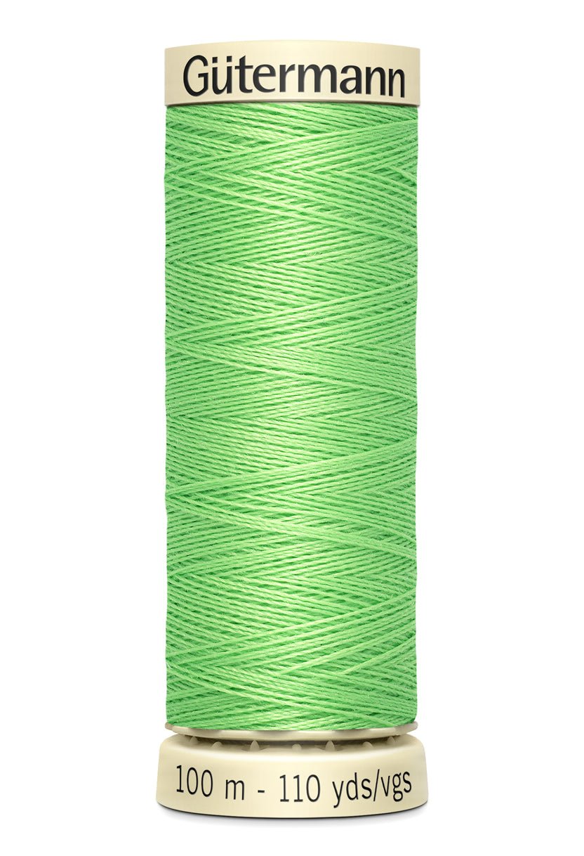 Gutermann green polyester sewing thread on a spool.