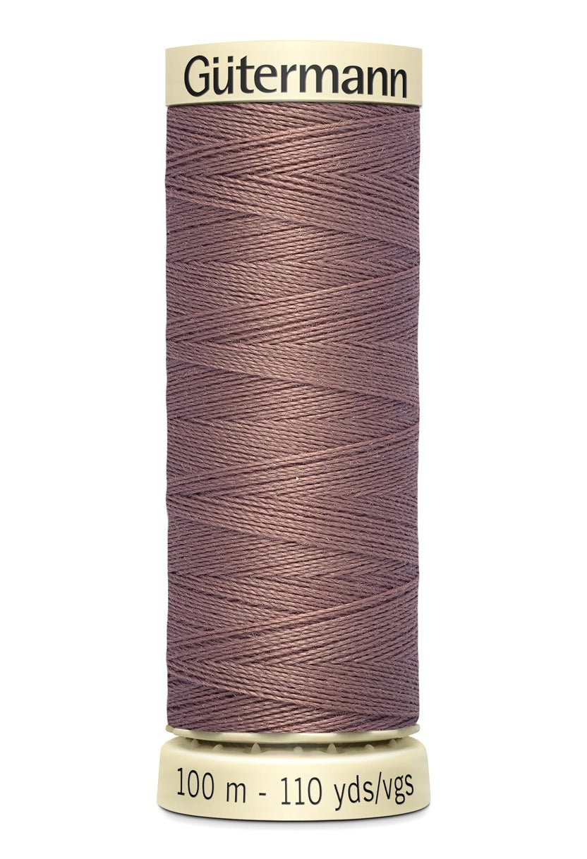 Gütermann Sew-All thread, 100% polyester, 100m spool, in a muted rose color.