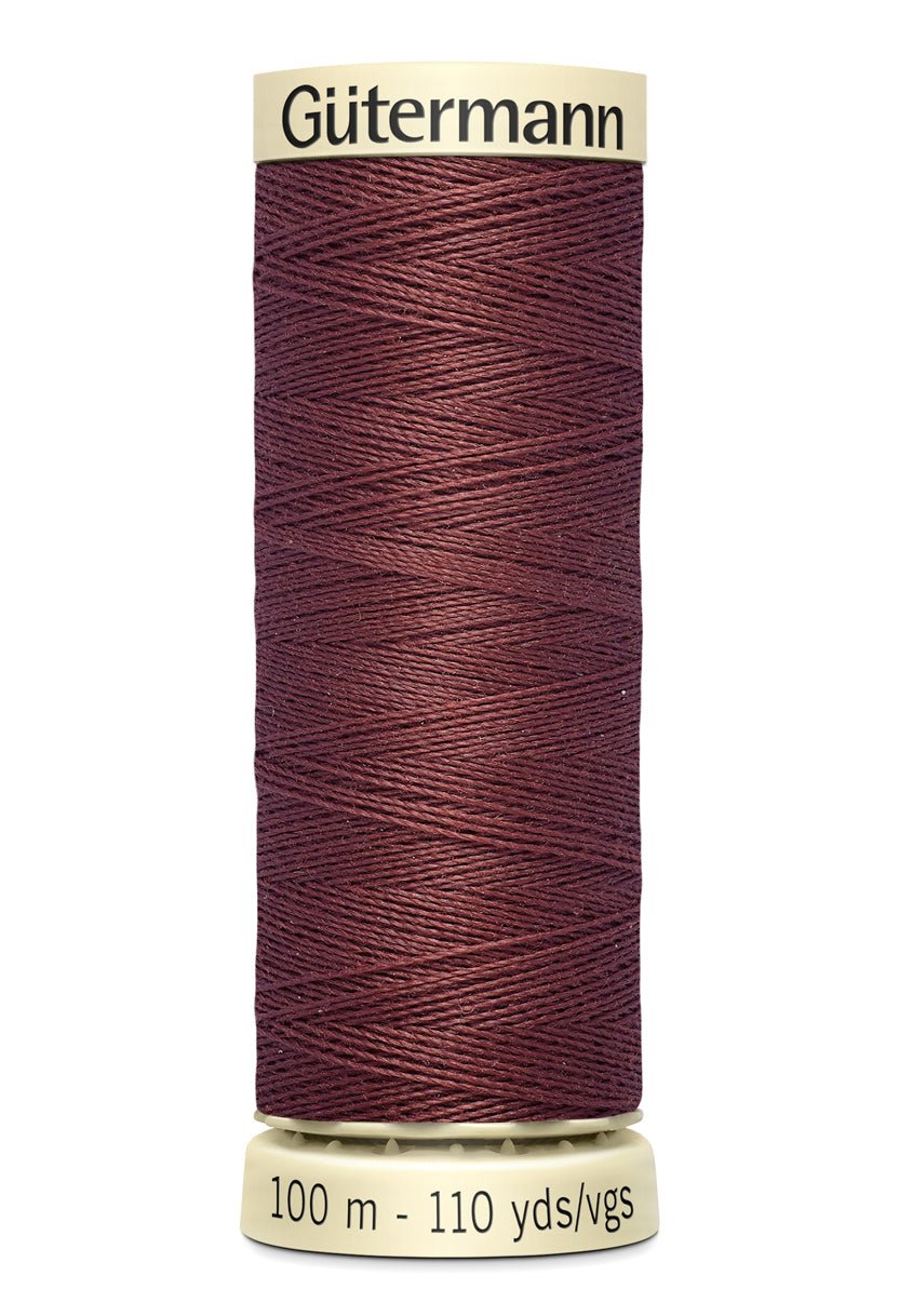 Gütermann Sew-All thread spool in a deep red color.