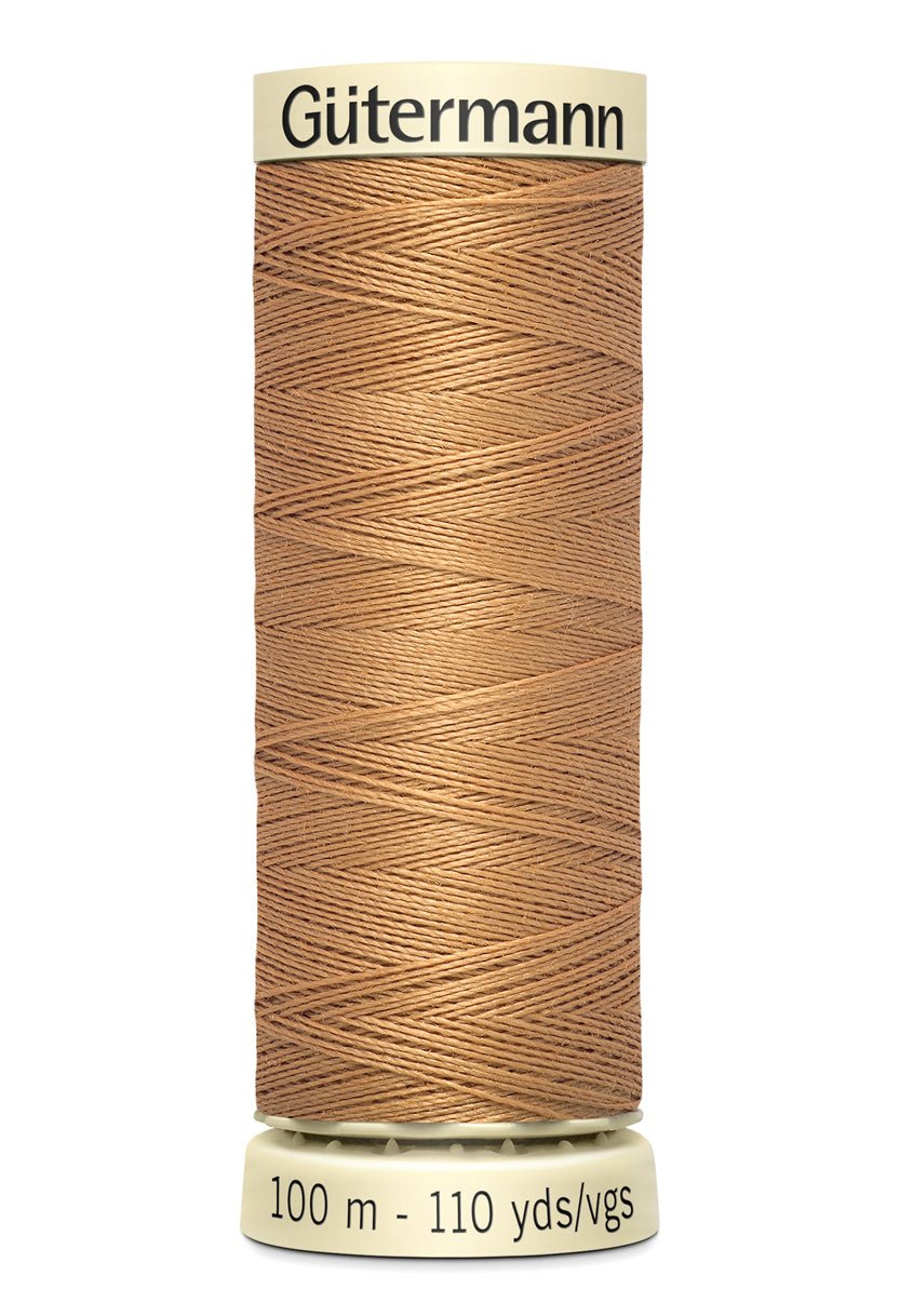 Gutermann Sew-All thread in a light brown color on a spool.