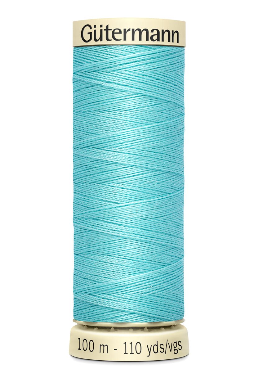 A spool of turquoise Gutermann Sew-All thread with "Gutermann" and "100 m - 110 yds/vgs" printed on it.