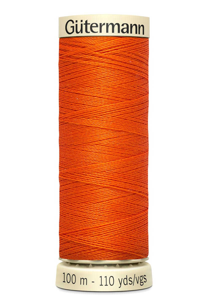 Gutermann Sew-All orange polyester sewing thread on a spool, 100m.