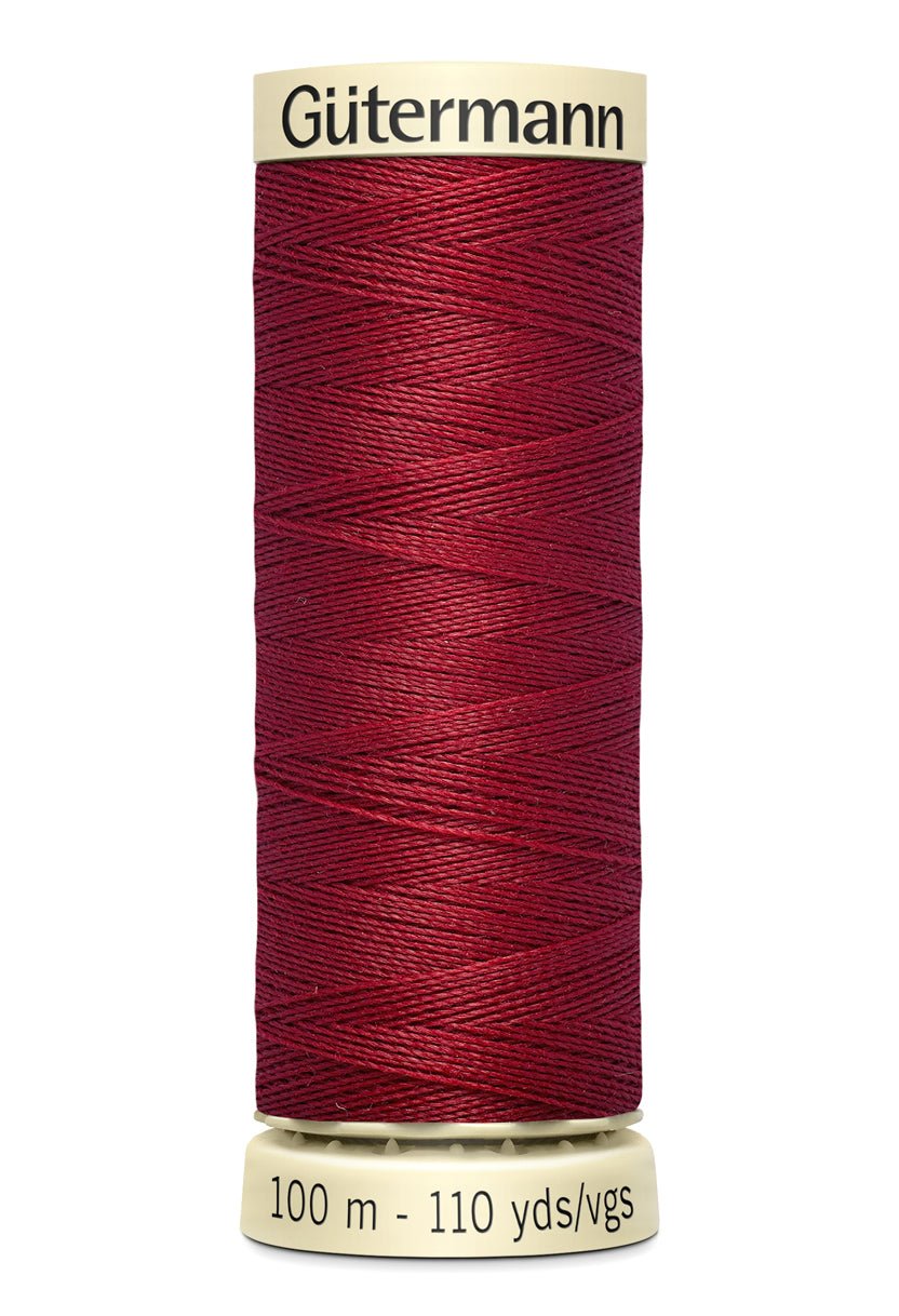 Gütermann Sew-All thread in a deep red color on a 100m spool.