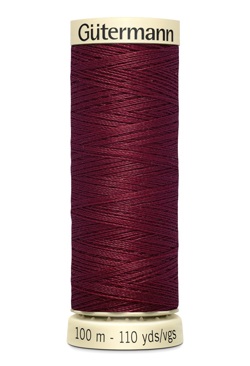 Gütermann Sew-All thread in a deep red color on a 100m spool.