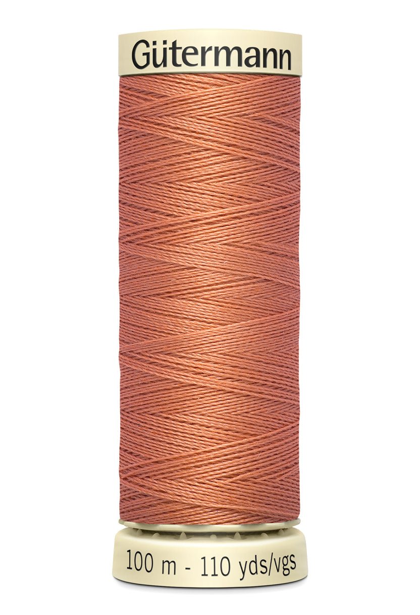 Gütermann Sew-All thread in a coral color on a 100m spool.