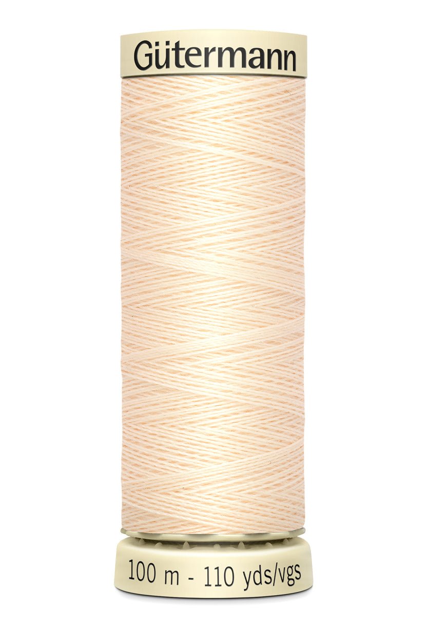 Gutermann Sew-All thread, 100% polyester, 100m spool in a light peach color.