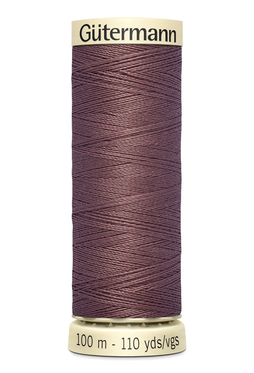 Gütermann Sew-All thread spool in a muted purple color.