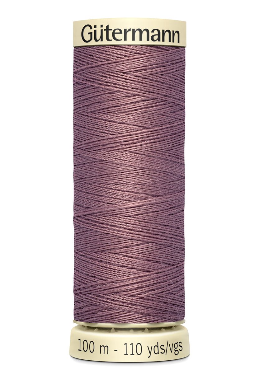Gütermann Sew-All thread spool in a muted purple color.