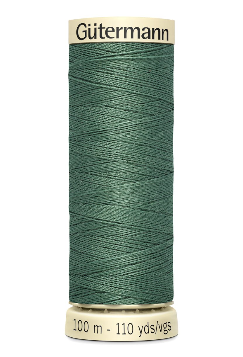 Gutermann Sew-All thread in a dark green color on a spool.