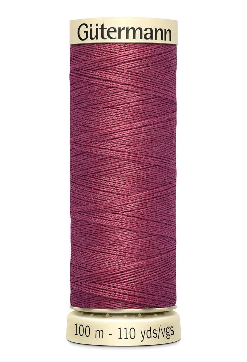 Gütermann Sew-All thread, 100m spool, in a deep pink color.