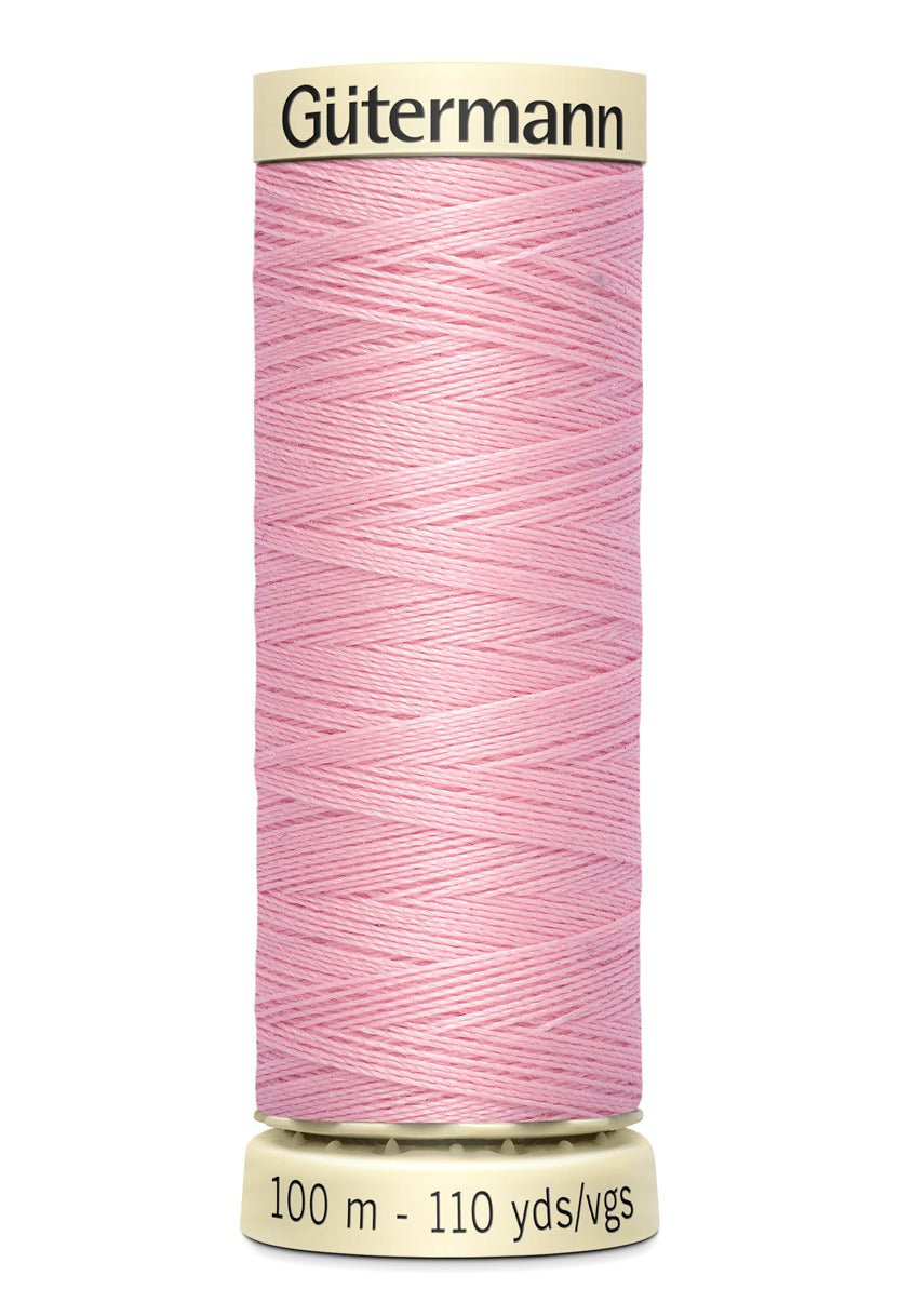 Gütermann pink polyester sewing thread on a 100m spool.