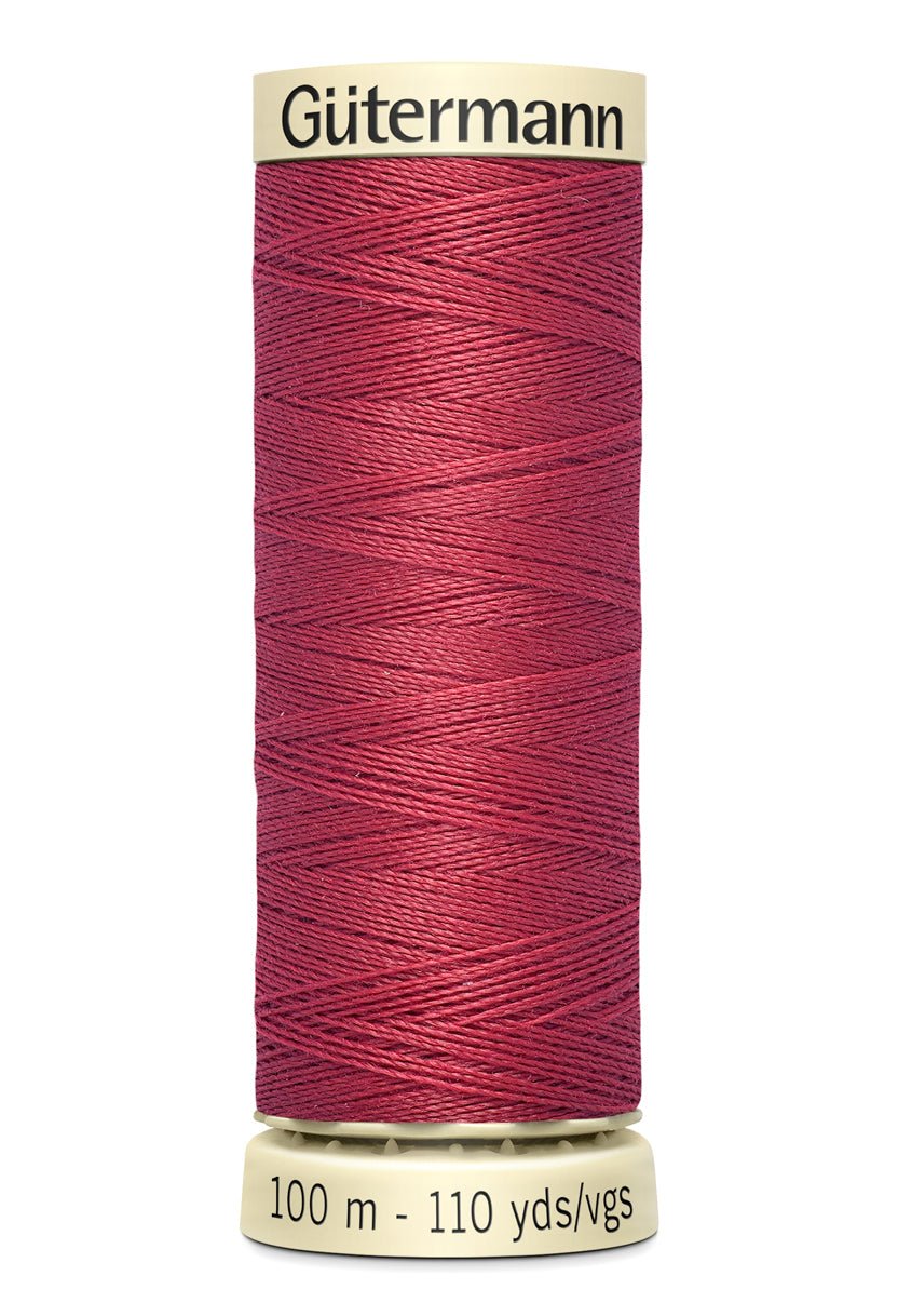 Gütermann Sew-All thread spool in a deep pink color.