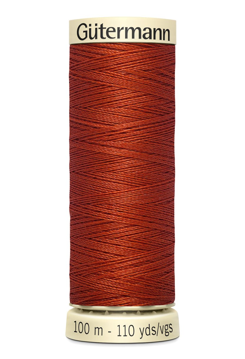 Gütermann Sew-All thread spool in rust color.