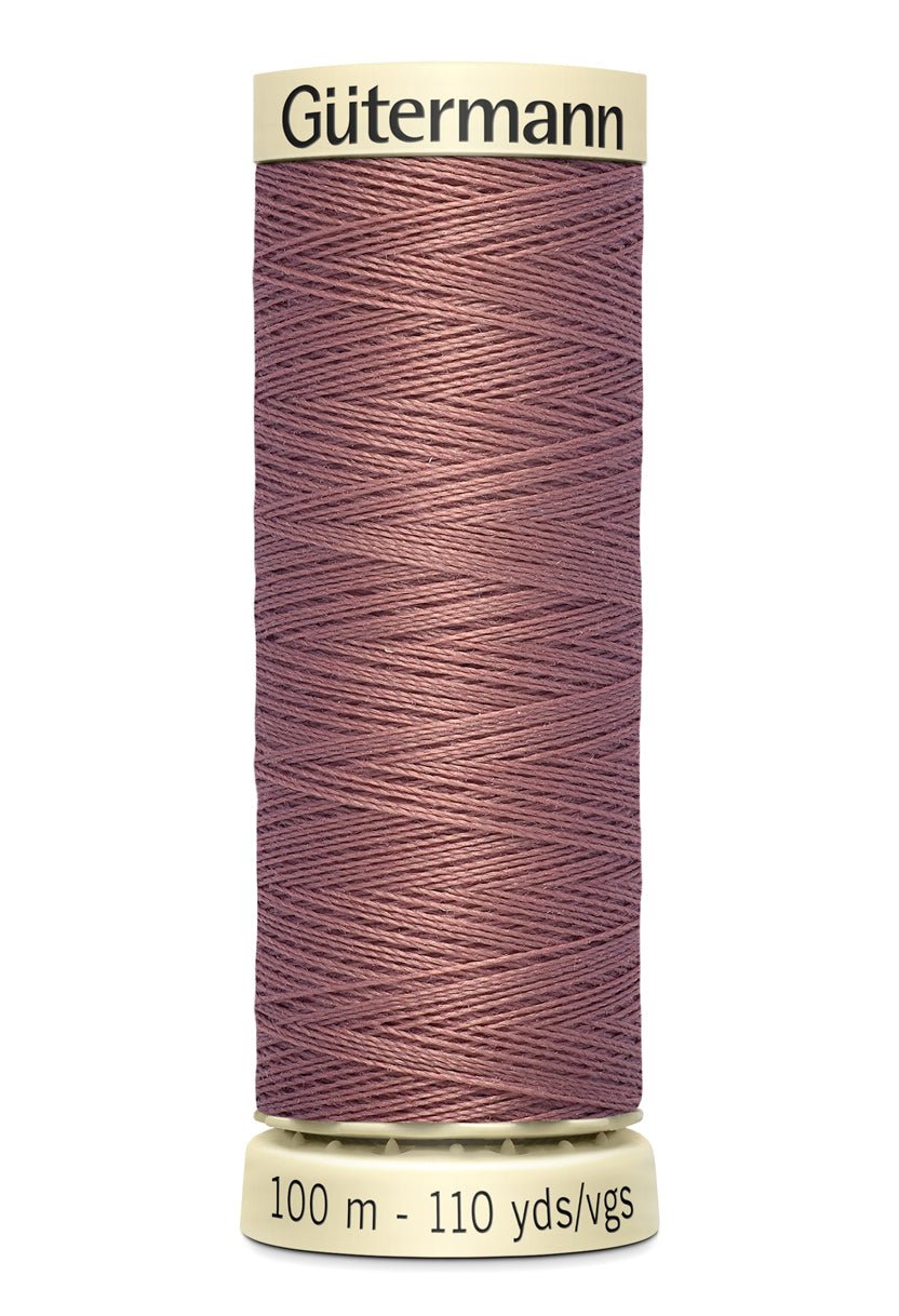 Gütermann Sew-All thread in a mauve color on a 100m spool.